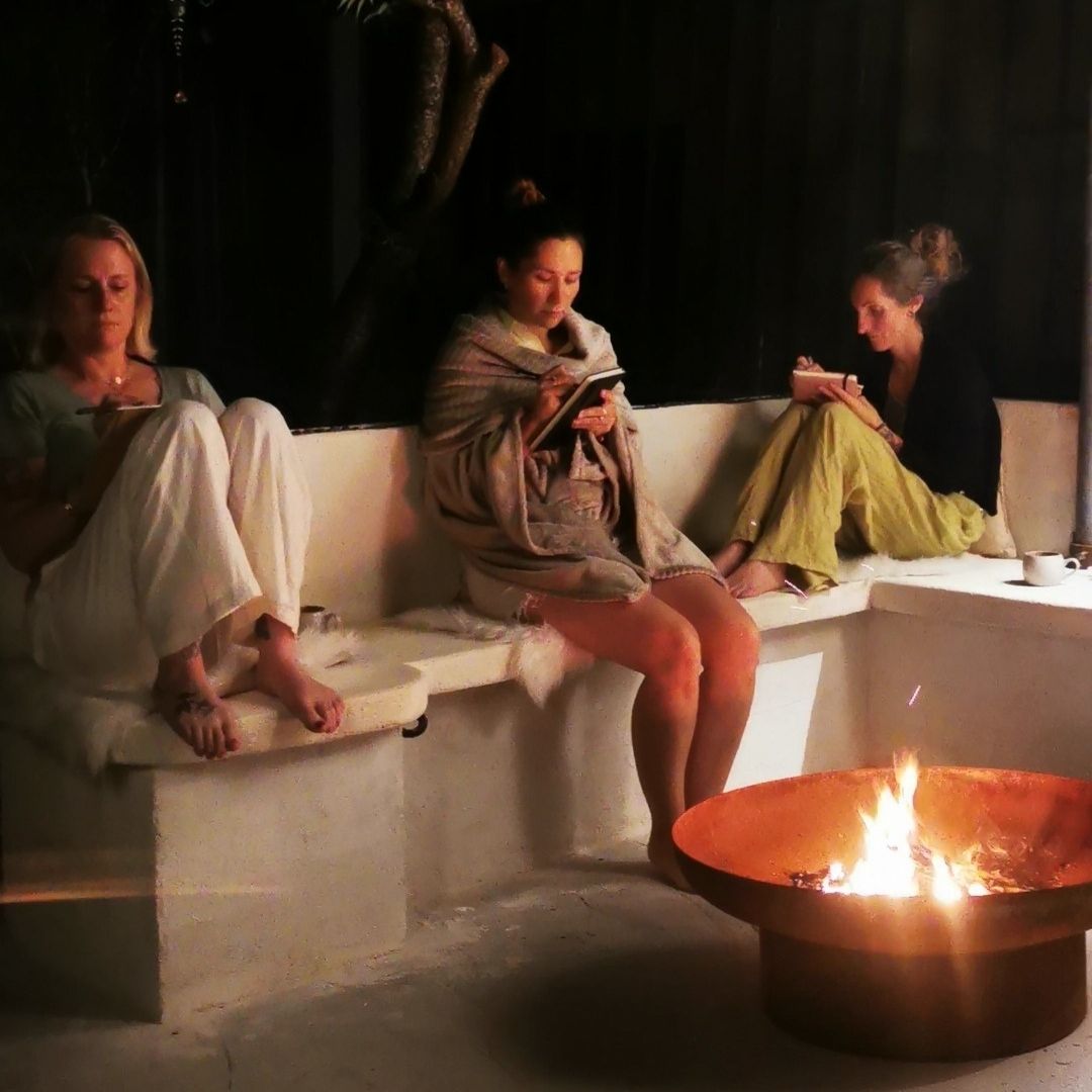Cercle de lune autour du feu avec écriture intuitive et rituels féminins.